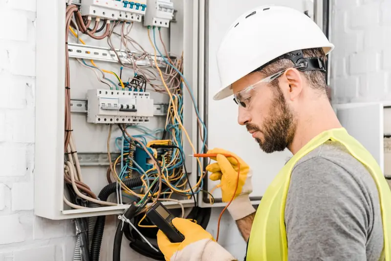 Electrician checking an electrical box